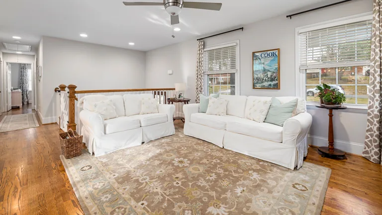 Flooring types for GTA homes: what to compare Bright living room with hardwood flooring and a large area rug